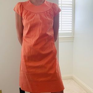 Coral short sleeve dress with pockets.